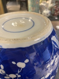 A pair of large Chinese blue and white 'prunus' jars and covers, 19th C.
